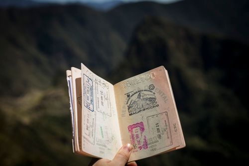 A person holding a passport booklet.