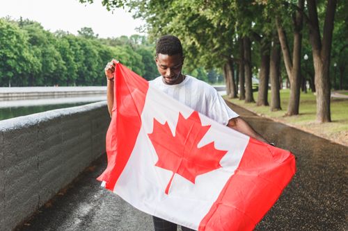 A man holding a Canadian flag